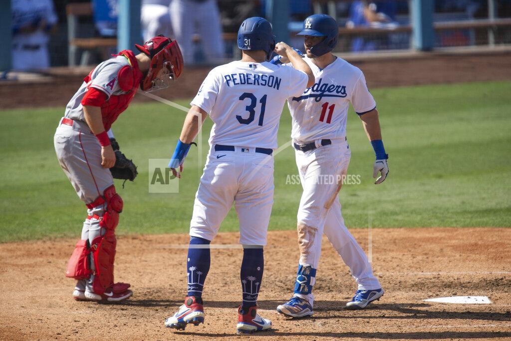 Kyusung Gong Los Angeles Dodgers' A.J. Pollock, right, celebrates his two-run home run with Joc Pederson, center, during the seventh inning of a baseball game against the Los Angeles Angels in Los Angeles, Sunday, Sept. 27, 2020. (AP Photo/Kyusung Gong)