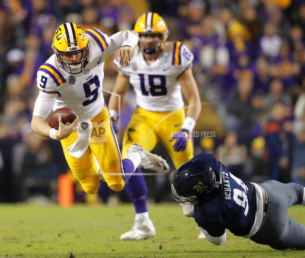 Gerald Herbert Rice defensive end Graysen Schantz (94) trips up LSU quarterback Joe Burrow (9) on a carry in the first half of an NCAA college football game in Baton Rouge, La., Saturday, Nov. 17, 2018. (AP Photo/Gerald Herbert)