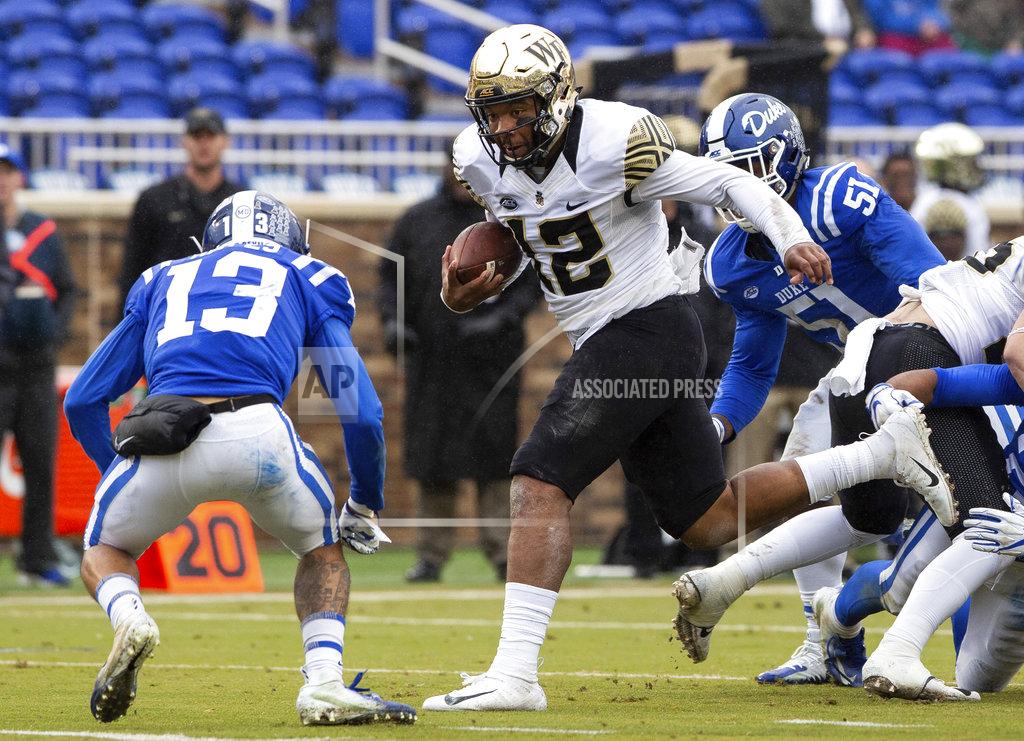 Ben Mckeown Wake Forest Quarterback Jamie Newman (12) carries the ball ahead of Duke's Jordan Hayes (13) during the first half of an NCAA college football game in Durham, N.C., Saturday, Nov. 24, 2018. (AP Photo/Ben McKeown)