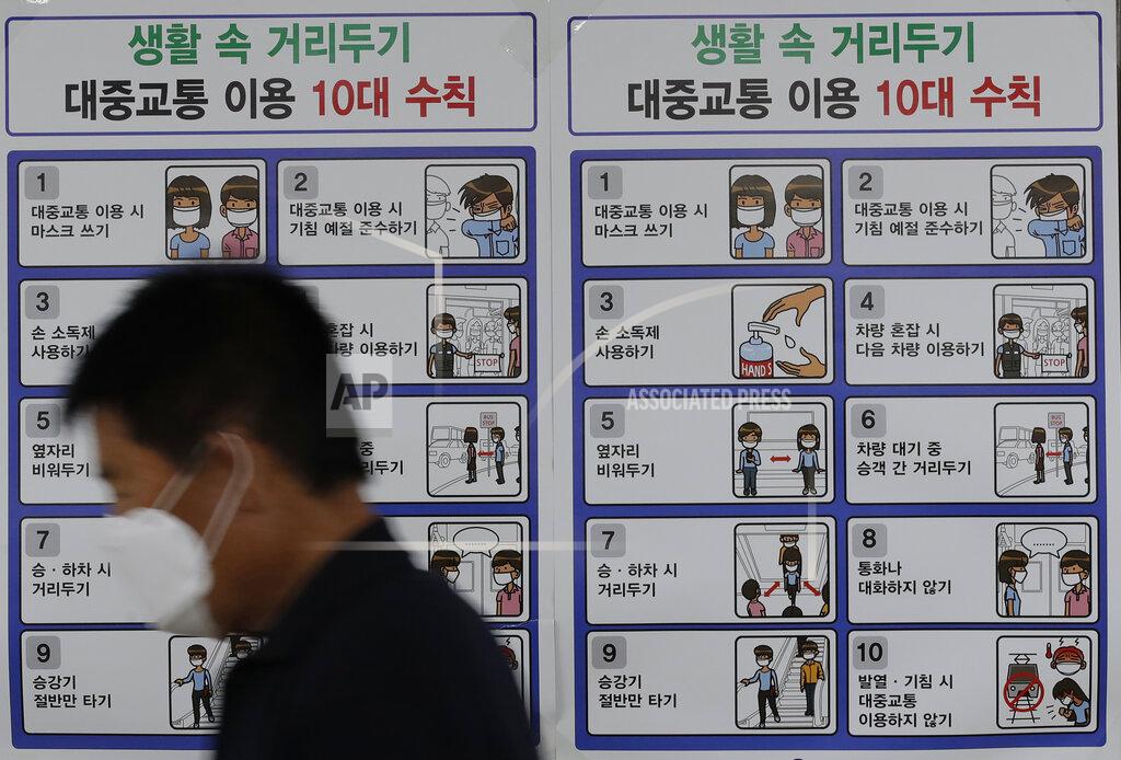 Lee Jin-Man A man wearing a face mask walks past a banner showing precautions against the coronavirus at subway station in Seoul, South Korea, Thursday, Sept. 10, 2020. (AP Photo/Lee Jin-man)