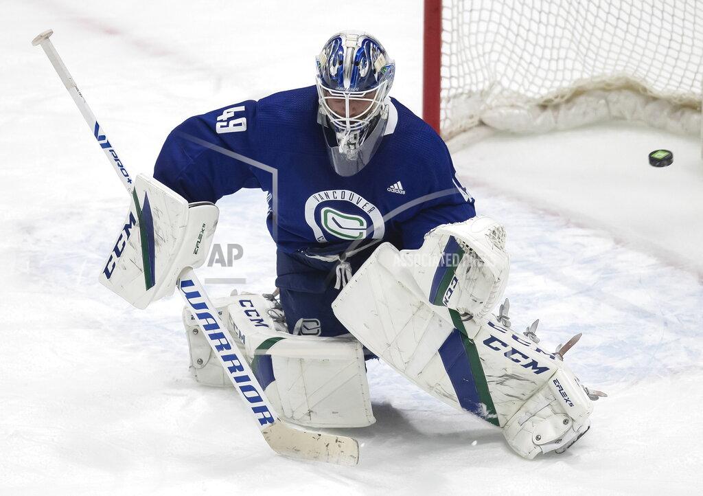 Darryl Dyck Vancouver Canucks goalie Braden Holtby allows a goal during the NHL hockey team's training camp in Vancouver, British Columbia, Monday, Jan. 11, 2021. (Darryl Dyck/The Canadian Press via AP)