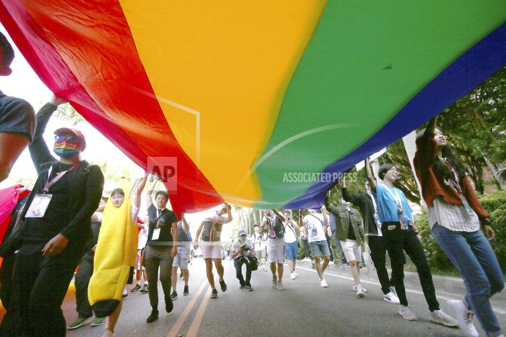 Chiang Ying-Ying Participants march through a street during a pride parade in Taipei, Taiwan, Saturday, Oct. 31, 2020. (AP Photo/Chiang Ying-ying)