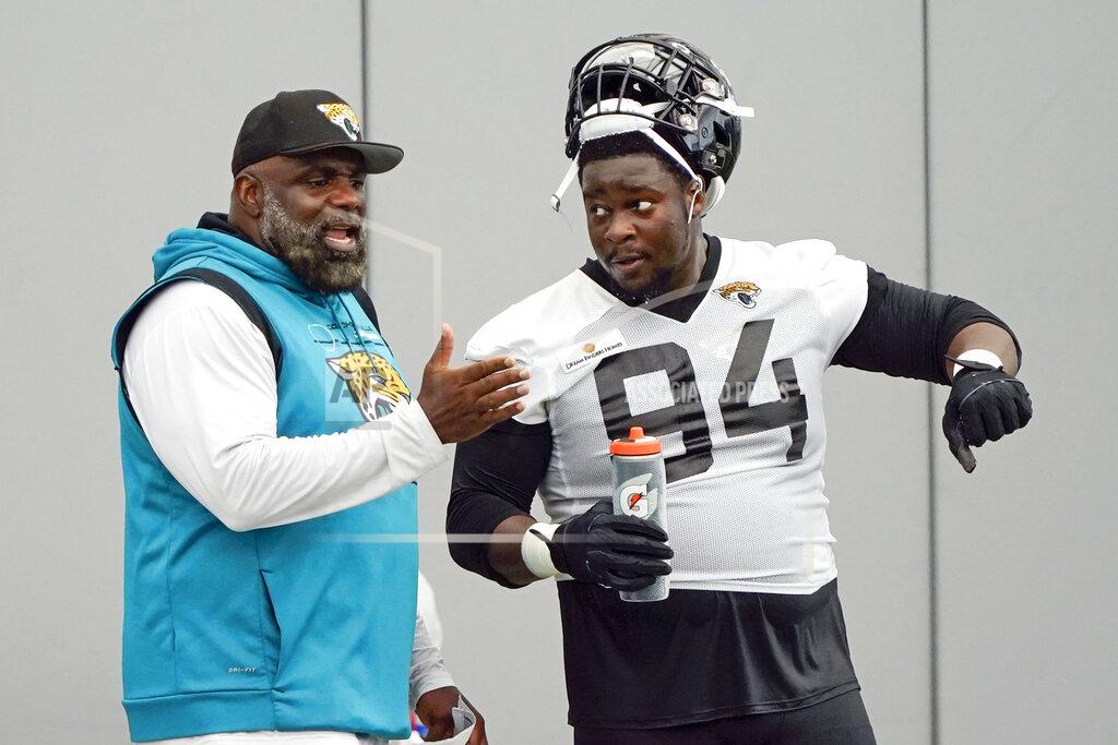 John Raoux Jacksonville Jaguars defensive tackle Foley Fatukasi (94) talks with defensive line coach Brentson Buckner, left, during an NFL football practice, Tuesday, May 31, 2022, in Jacksonville, Fla. (AP Photo/John Raoux)