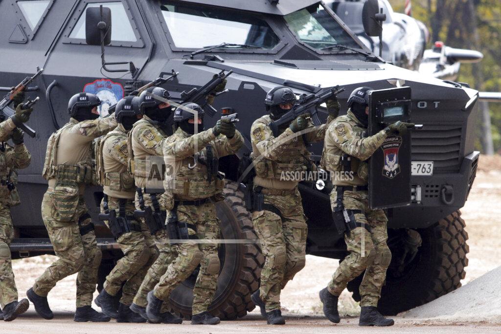Uncredited Members of the police forces of Bosnia's Serb-run part aim their weapons during exercises on the Jahorina Mountain, Bosnia and Herzegovina, Friday, Oct. 22, 2021. The exercises on Jahorina Mountain, outside Sarajevo, and in the northern town of Mrkonjic Grad, were staged just days after Bosnian Serb top leader, Milorad Dodik, announced that the country's Serb-run part will quit the key multi-ethnic state institutions. (AP Photo)
