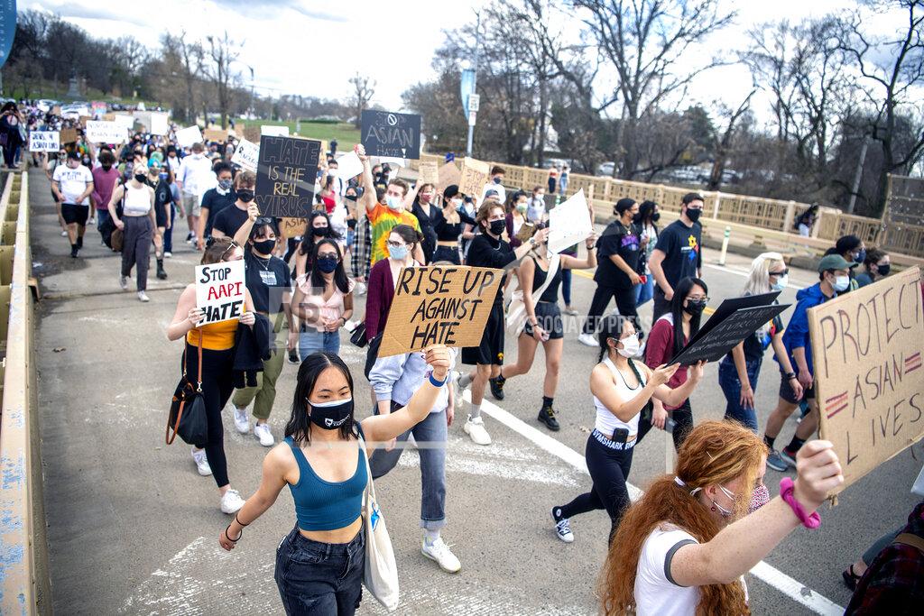 Attendees march from Pittsburgh's Flagstaff Hill to Schenley Plaza during the "PGH Rally for Solidarity" event to protest recent acts of violence towards Asian Americans, Wednesday, March 24, 2021, in the Oakland neighborhood of Pittsburgh. The rally was organized by the East Coast Asian American Student Union (ECAASU) and the Asian Pacific American Labor Alliance (APALA). (Alexandra Wimley/Pittsburgh Post-Gazette via AP)