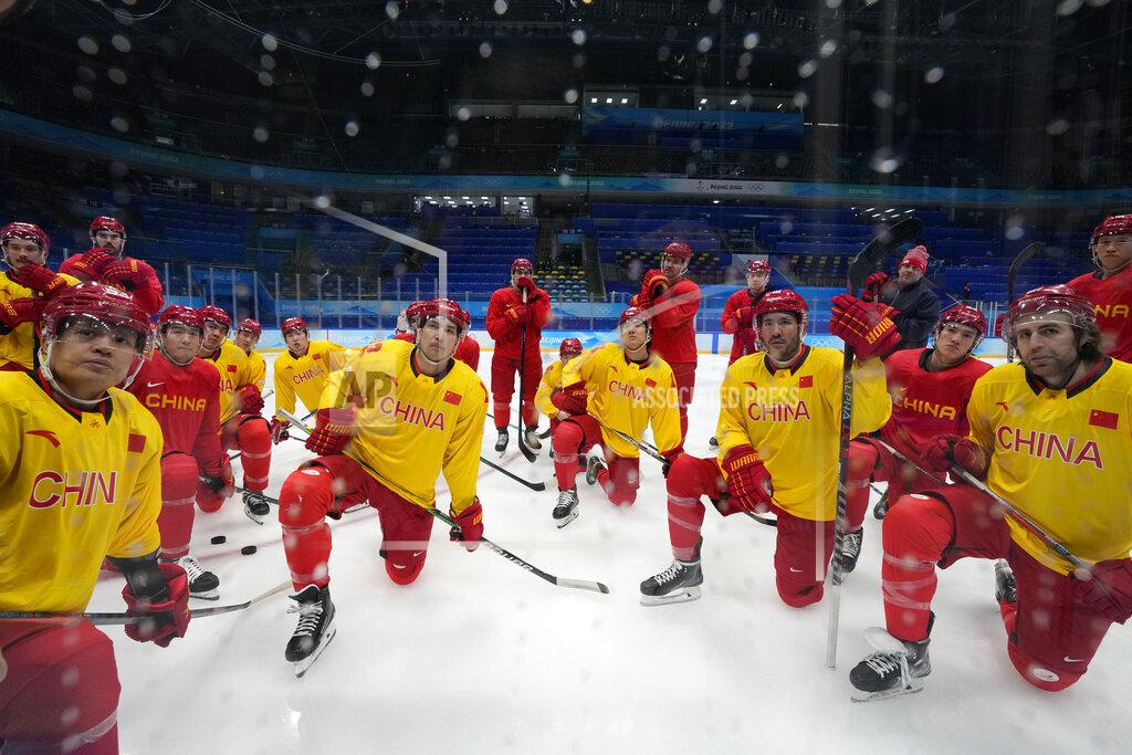 Petr David Josek China players listen to their coaching staff during a men's hockey practice session at the 2022 Winter Olympics, Sunday, Jan. 30, 2022, in Beijing. (AP Photo/Petr David Josek)