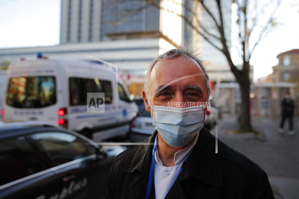 Dr. Philippe Montravers speaks with The Associated Press at the main entrance of the Bichat Hospital, in Paris on Tuesday, Nov. 10, 2020. Montravers and the 150 doctors and nurses he leads have become experts about how to treat COVID-19. That knowledge is proving invaluable against a second deadly surge of the virus is again threatening to overwhelm European health systems. (AP Photo/Francois Mori)