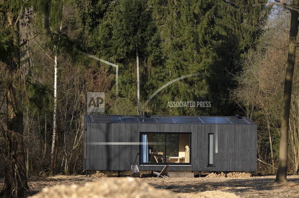 Virginia Mayo Solar panels on the roof generate energy for a Slow Cabin in Zandbergen, Belgium, Sunday, Feb. 28, 2021. These Slow Cabins, set up the Belgian countryside, are the new way to vacation in pandemic times: in complete solitude and in the middle of nowhere. The wooden cabins are fully sustainable, provided you don't stay in the shower too long and you can live without Wi-Fi. (AP Photo/Virginia Mayo)