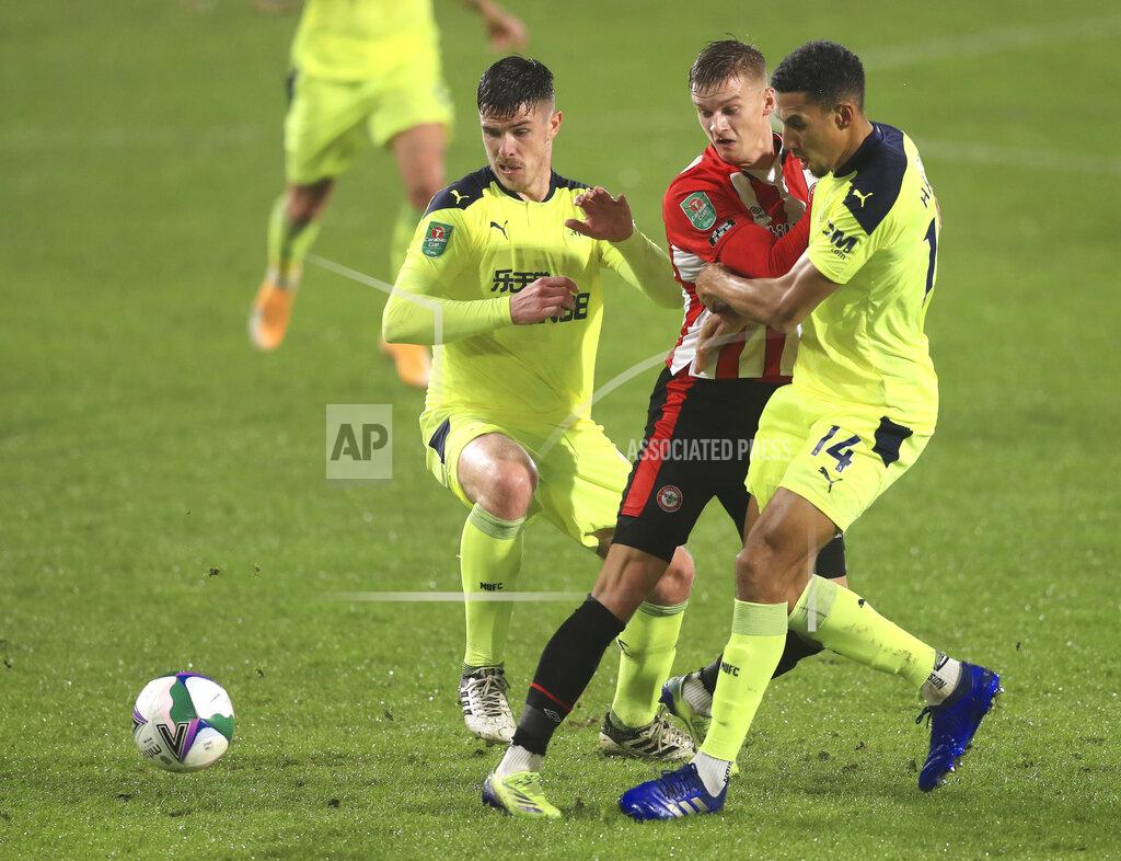 Newcastle's Ciaran Clark, left, Newcastle's Isaac Hayden, right, and Brentford's Marcus Forss challenge for the ball during the EFL Cup soccer match between Brentford and Newcastle United at Brentford Community Stadium in London, England, Tuesday, Dec. 22, 2020. (Adam Davy/Pool via AP)