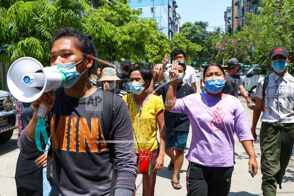 Uncredited Young demonstrators flash the three-fingered symbol of resistance as they march in Yangon, Myanmar, Saturday, April 10, 2021. Security forces in Myanmar cracked down heavily again on anti-coup protesters Friday even as the military downplayed reports of state violence.(AP Photo)