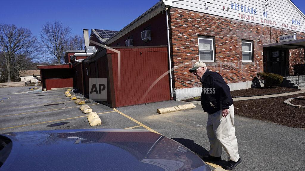 Charles Krupa Paul Guilbeault, quartermaster at Veterans of Foreign Wars Post #3260, walks through the empty parking lot of the former post, Friday, March 12, 2021, in New Bedford, Mass. Guilbeault knew the writing was on the wall for the last Veterans of Foreign Wars post in this city south of Boston when businesses across Massachusetts were ordered to close as the coronavirus pandemic took hold last March. (AP Photo/Charles Krupa)
