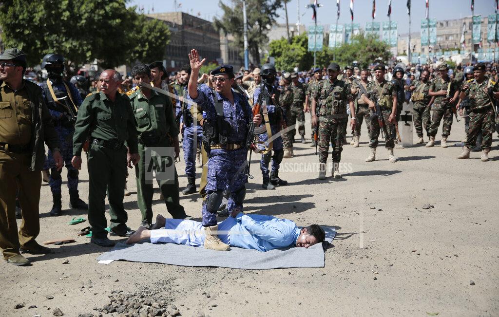 Hani Mohammed An executioner gestures before he shoots a man convicted of involvement in the killing of a senior Houthi official Saleh al-Samad at Tahrir Square in Sanaa, Yemen Saturday, Sept. 18, 2021. Yemen’s Houthi rebels say they have executed nine people for their alleged involvement in the killing of the senior Houthi official in an airstrike by the Saudi-led coalition more than three years ago.(AP Photo/Hani Mohammed)