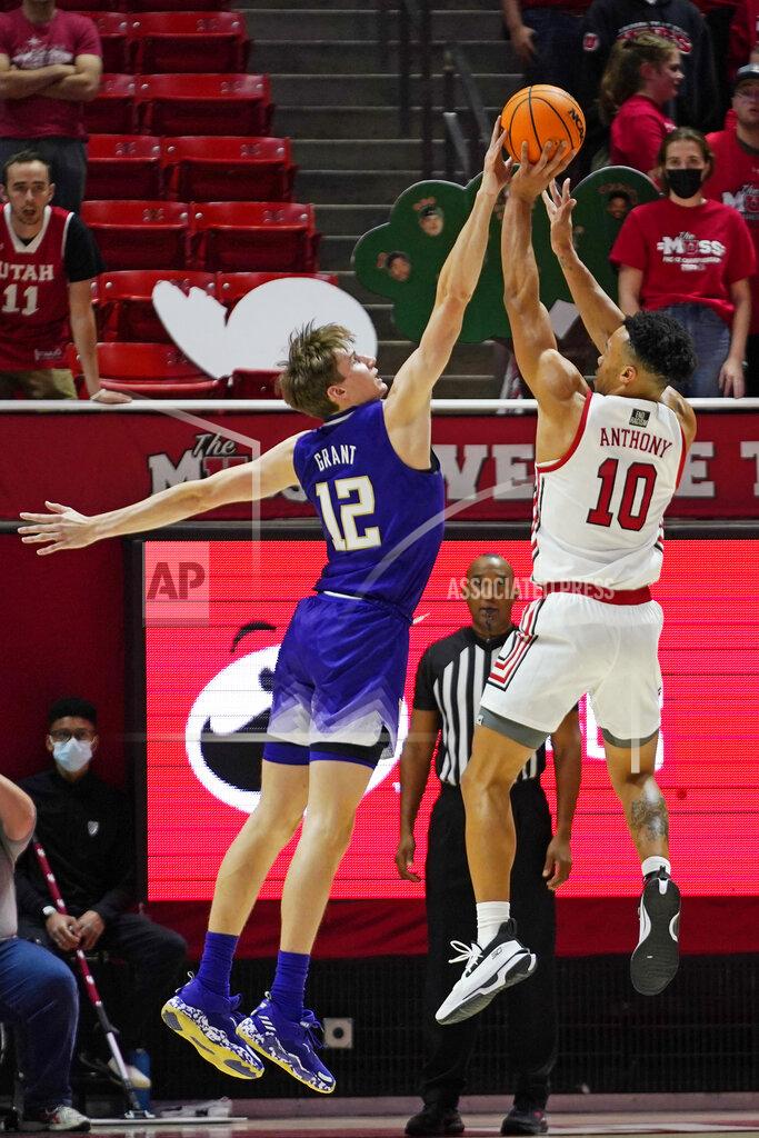 Rick Bowmer Washington forward Jackson Grant (12) blocks the shot of Utah guard Marco Anthony (10) during the first half of an NCAA college basketball game Thursday, Jan. 6, 2022, in Salt Lake City. (AP Photo/Rick Bowmer)