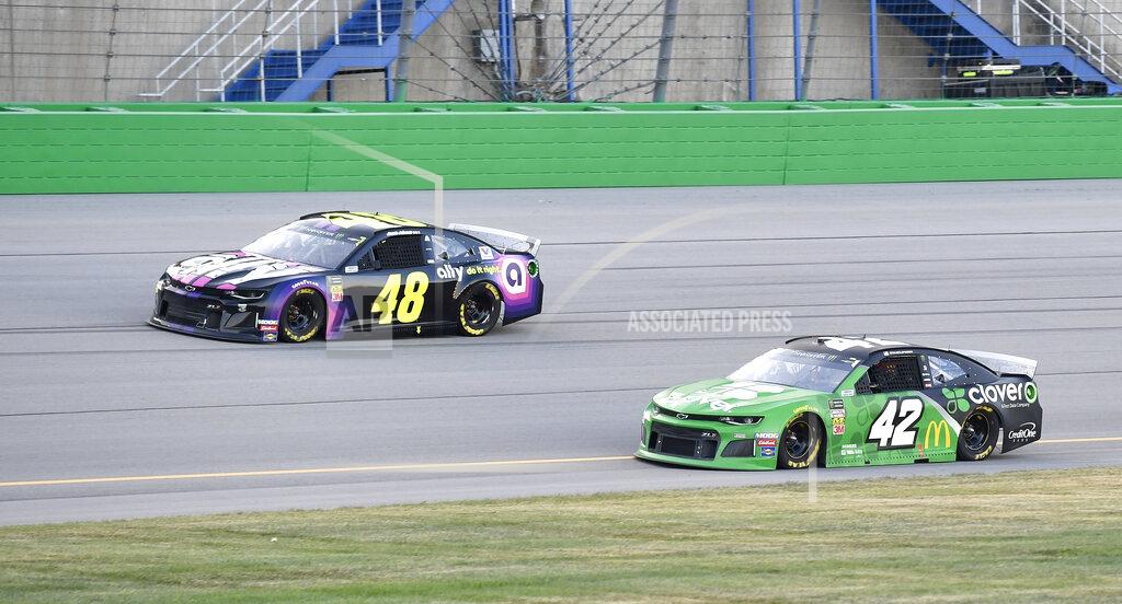 Timothy D. Easley Jimmie Johnson (48) drives next to Kyle Larson (42) during the NASCAR Cup Series auto race at Kentucky Speedway in Sparta, Ky., Saturday, July 13, 2019. (AP Photo/Timothy D. Easley)