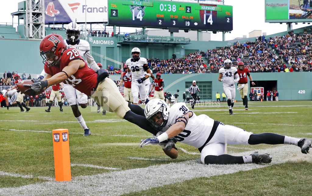 Charles Krupa Harvard wide receiver Henry Taylor (28) stretches for a touchdown against Yale linebacker Noah Pope (30) during the first half of an NCAA college football game at Fenway Park in Boston, Saturday, Nov. 17, 2018. (AP Photo/Charles Krupa)