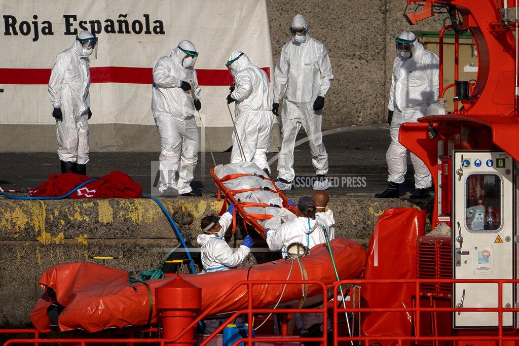 Emilio Morenatti Emergency workers carry a migrant’s body after being found dead by the Spanish Maritime Rescue Service, at the Arguineguin port in Gran Canaria island, Spain, on Friday, Aug. 21, 2020. Spanish authorities say that five migrants have died and 11 survived while trying to reach the Canary Islands, bringing to 20 the number of people who have lost their lives that week in the perilous migration route to Europe. (AP Photo/Emilio Morenatti)