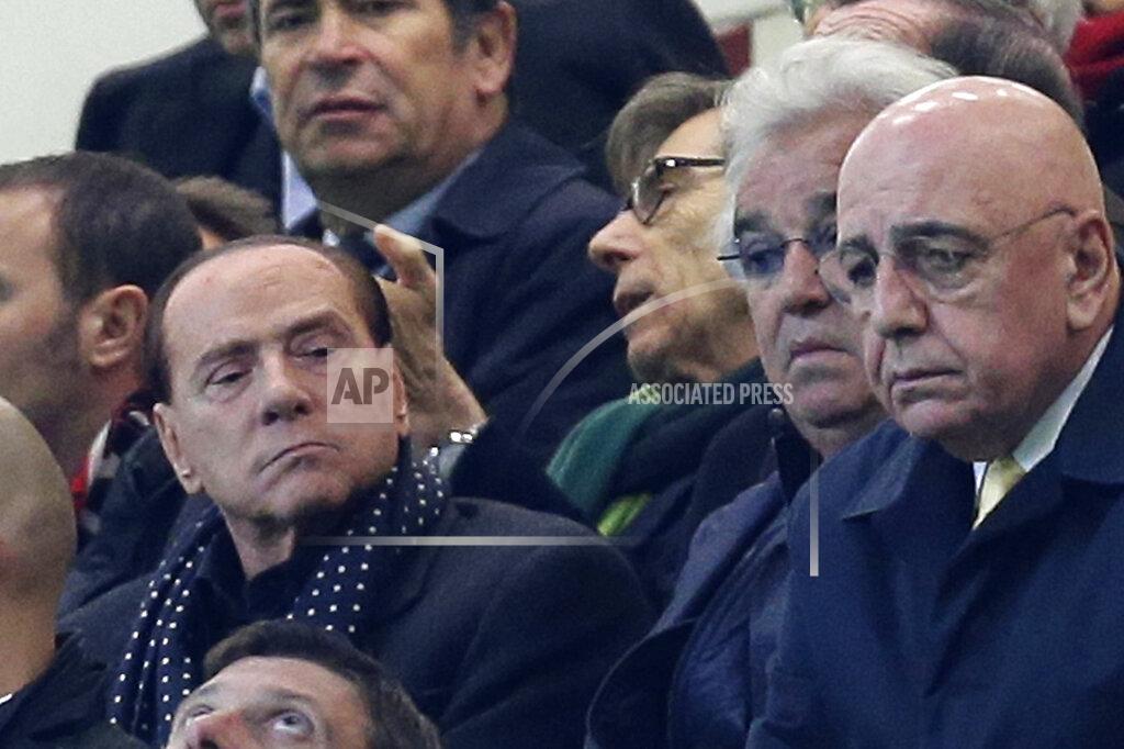 Antonio Calanni FILE - In this Nov. 6, 2012 file photo, Silvio Berlusconi, left, sits next to businessman Flavio Briatore, and former AC Milan CEO Adriano Galliani, right as he attends a match t the San Siro stadium in Milan, Italy. Italy’s former prime minister and right-wing leader Silvio Berlusconi has tested positive to coronavirus after a precautionary check, his press office said on Wednesday, Sept. 2, 2020. The three-time-premier and media tycoon had been recently seen with his old-time friend and businessman Flavio Briatore, who was recently hospitalized after testing positive to Covid-19 last month. Berlusconi had tested negative at the time. (AP Photo/Antonio Calanni)