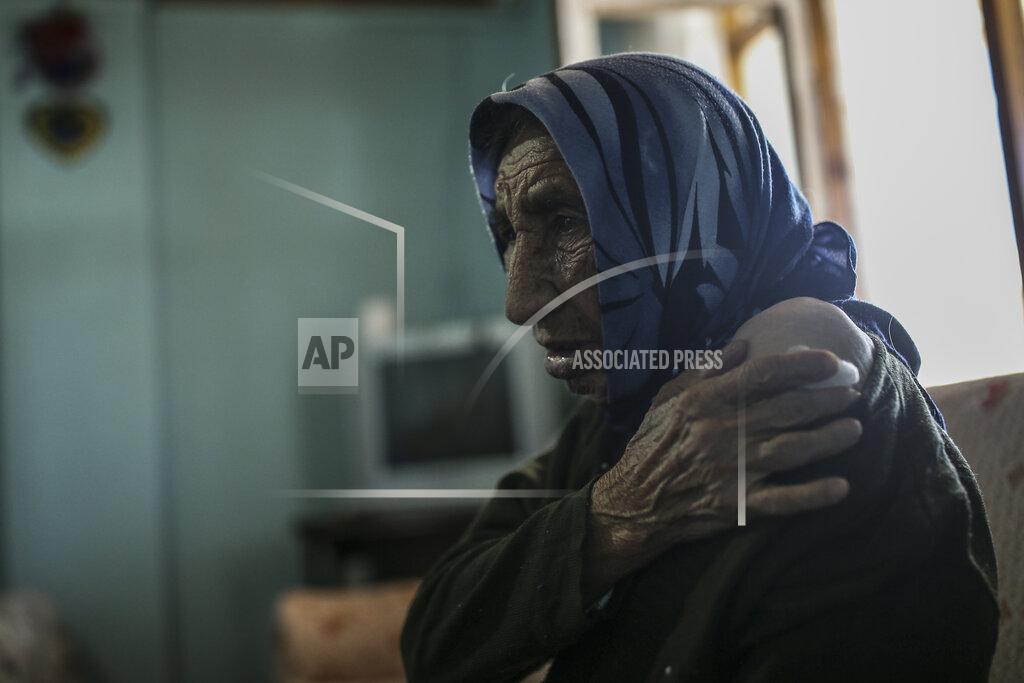 Emrah Gurel Altun Yigit, 83, rests after she was administered a CoronaVac vaccine made by China's Sinovac Biotech Ltd. by a visiting medical team at her house in the isolated village of Gumuslu of the district of Sivas, central Turkey, Friday, Feb. 26, 2021. (AP Photo/Emrah Gurel)