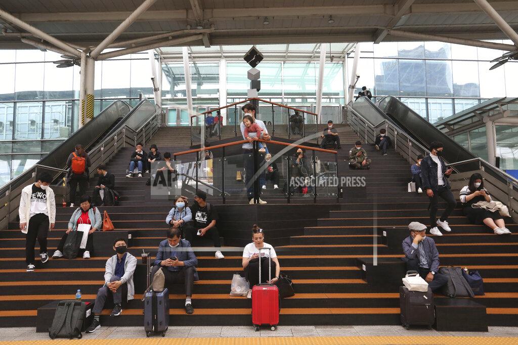 Ahn Young-Joon Passengers wearing face masks wait for their trains at the Seoul Railway Station in Seoul, South Korea, Saturday, May 2, 2020. South Korea reported fresh cases of the new coronavirus are continuing a month-long downnturn. (AP Photo/Ahn Young-joon)