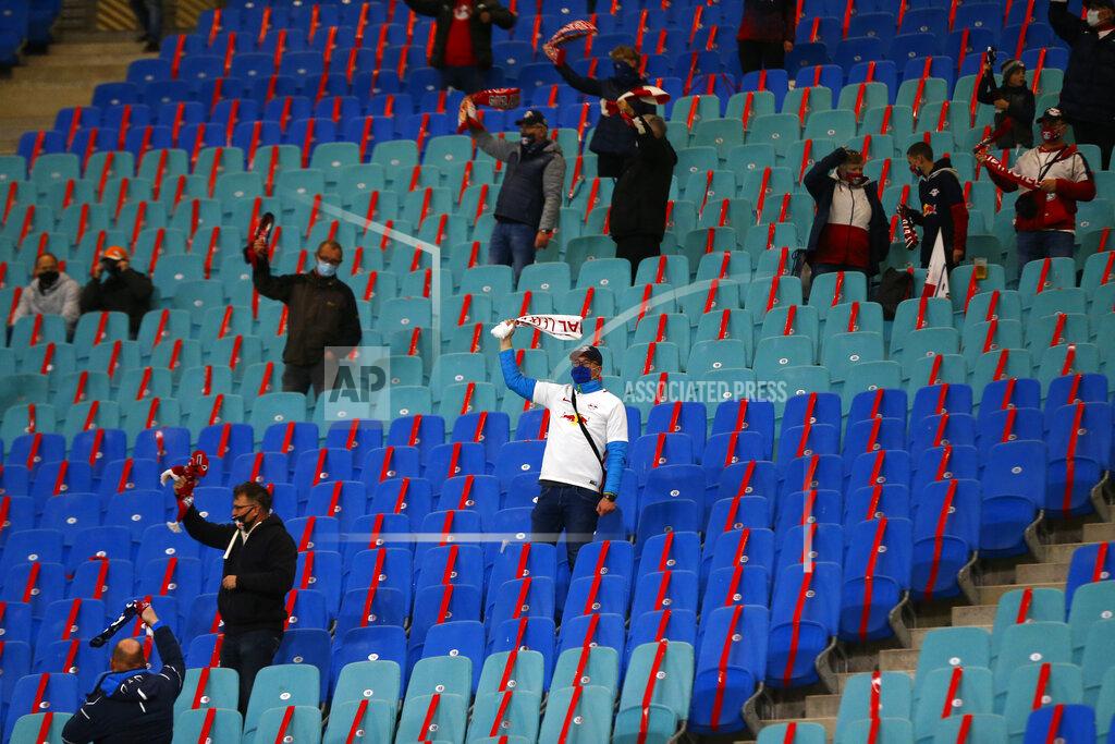 Markus Schreiber A small group of fans wait for the start of a Group H Champions League soccer match between RB Leipzig and Istanbul Basaksehir at the RB Arena in Leipzig, Germany, Tuesday Oct. 20, 2020. (AP Photo/Markus Schreiber)