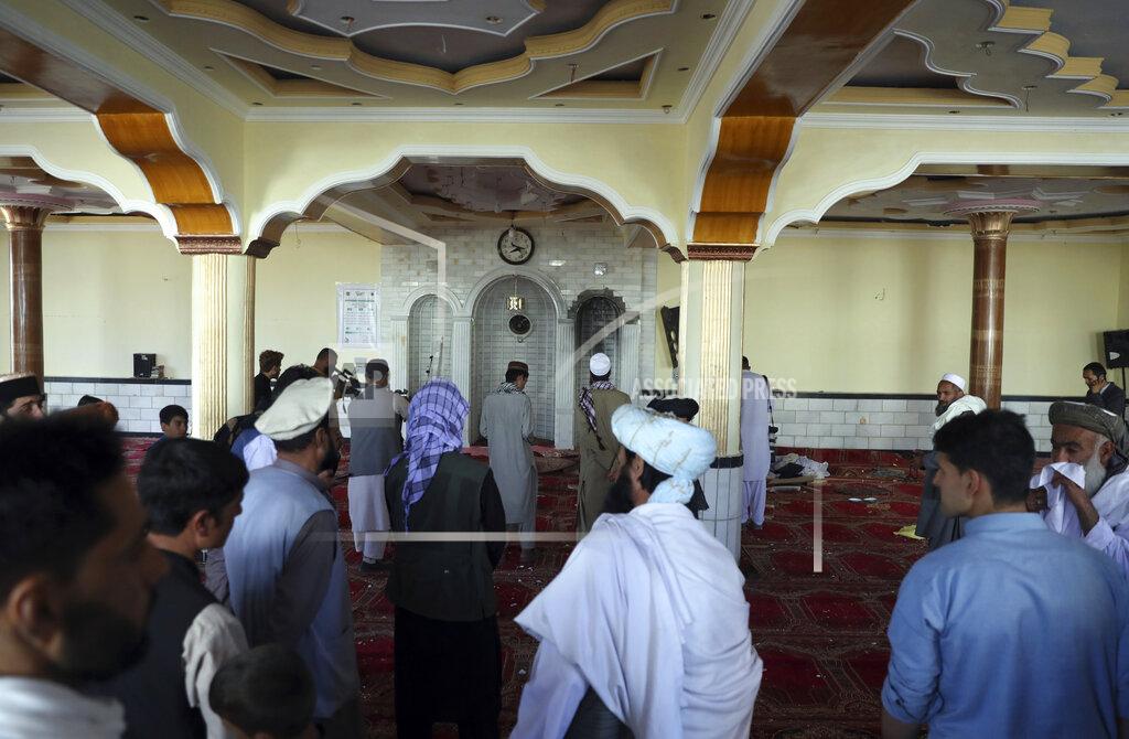 Rahmat Gul People stand inside a mosque after a bomb explosion in Shakar Dara district of Kabul, Afghanistan, Friday, May 14, 2021. A bomb ripped through a mosque in northern Kabul during Friday prayers killing 12 worshippers, Afghan police said. (AP Photo/Rahmat Gul)