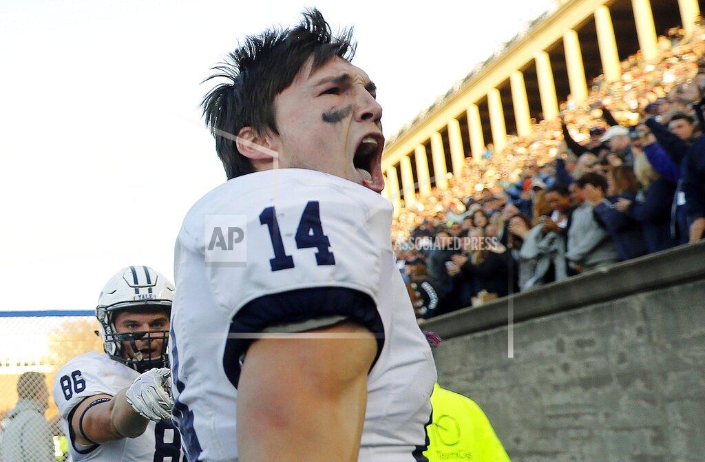 Winslow Townson FILE - In this Nov. 19, 2016, file photo, Yale wide receiver Reed Klubnik celebrates with fans and teammate tight end John Lager, left, after scoring the winning touchdown during the second half of Yale's victory over Harvard in an NCAA football game at Harvard Stadium in Cambridge, Mass. Yale quarterback Kurt Rawlings has rewritten the school's record books for passing, throwing the ball to Klubnik and JP Shohfi, who he convinced to come with him to the Ivy League. (AP Photo/Winslow Townson, File)