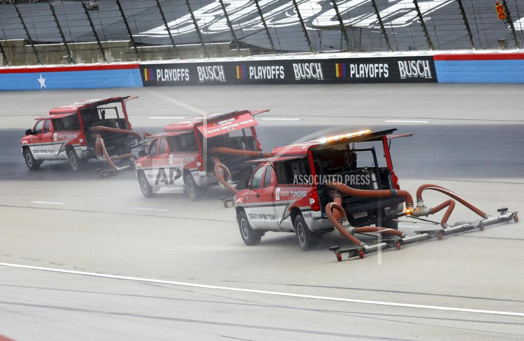 Richard W. Rodriguez Drying trucks continue to prepare the track for a possible NASCAR Cup Series auto race at Texas Motor Speedway in Fort Worth, Texas, Tuesday, Oct. 27, 2020. The race was stopped on Sunday because of drizzle and misty conditions that allowed drivers to complete just 52 of 334 laps. Another 115 laps have to be completed to get to the halfway mark of 167 laps that would make Texas an official race. (AP Photo/Richard W. Rodriguez)