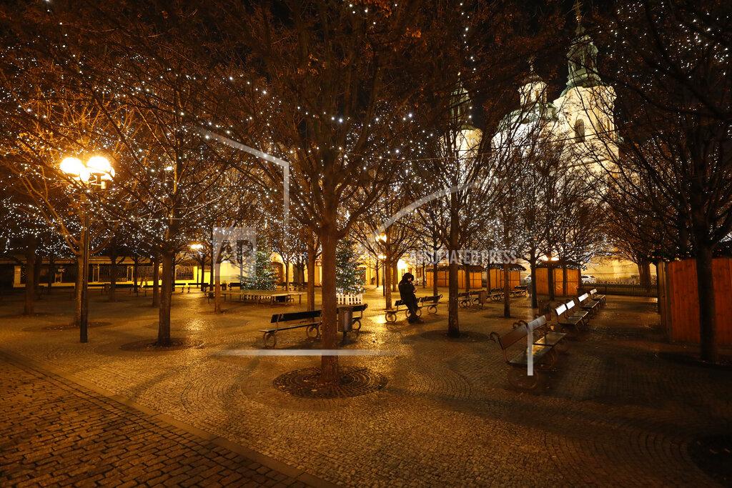 Petr David Josek A security guard sits in the park near the Old Town Square in Prague, Czech Republic, Friday, Jan. 1, 2021. Due to the surge in coronavirus infections police boosted their presence across the country on New Year's Eve to enforce a night-time curfew starting at 9 p.m. and other strict restrictive measures imposed by the government that make it impossible to stage traditional New Year's celebrations. (AP Photo/Petr David Josek)