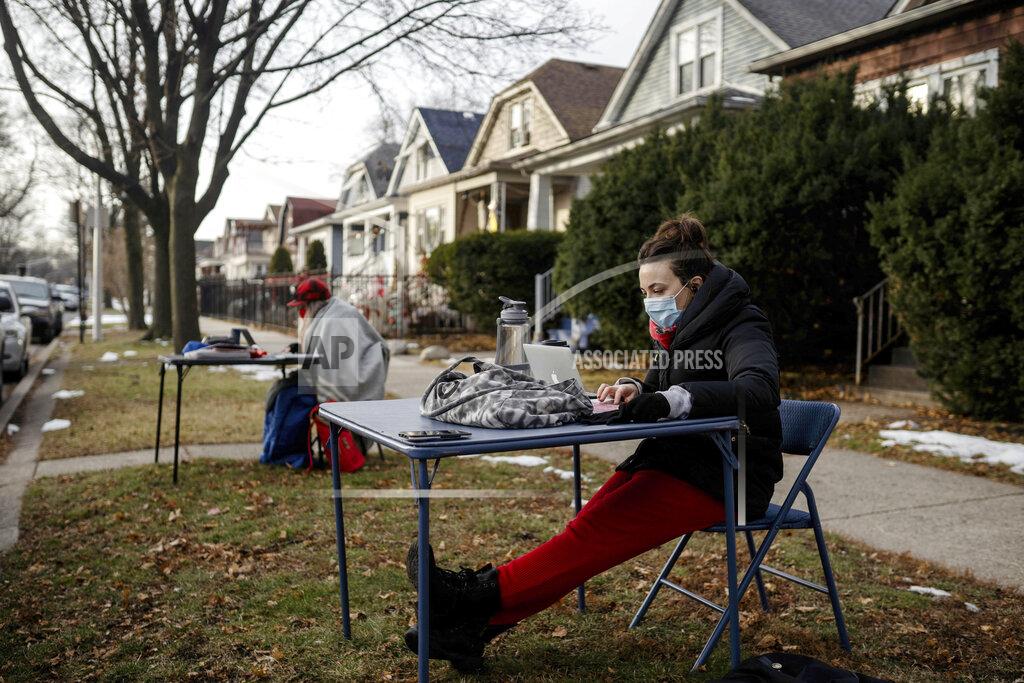 Pat Nabong FILE - In this Jan. 13, 2021 file photo, Meghan Hayes, who teaches at John Hay Community Academy, teaches her class outside Chicago Public Schools Board President Miguel del Valle's home, in Chicago. After seeing two academic years thrown off course by the pandemic, school leaders around the country are planning for the possibility of more distance learning next fall at the start of yet another school year. (Pat Nabong/Chicago Sun-Times via AP, File)