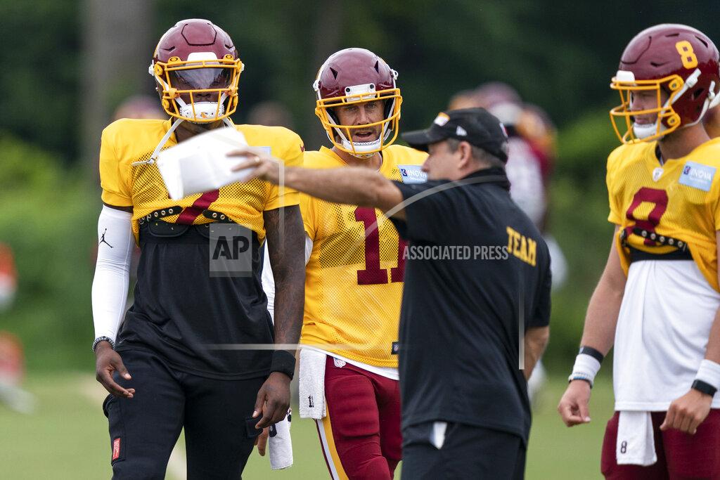 Washington quarterbacks Dwayne Haskins Jr., left, Alex Smith and Kyle Allen take direction during practice at the team's NFL football training facility, Wednesday, Aug. 19, 2020, in Ashburn, Va. (AP Photo/Alex Brandon)