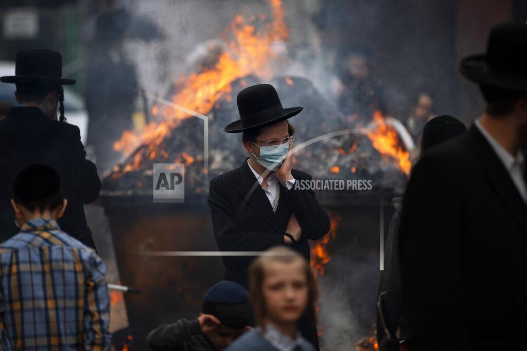 Oded Balilty Ultra-Orthodox Jewish men and children, some wearing face mask, burn leavened items in final preparation for the Passover holiday in the ultra-Orthodox Jewish town of Bnei Brak, near Tel Aviv, Israel, Friday, March 26, 2021. Jews are forbidden to eat leavened foodstuffs during the Passover holiday that celebrates the biblical story of the Israelites' escape from slavery and exodus from Egypt. (AP Photo/Oded Balilty)