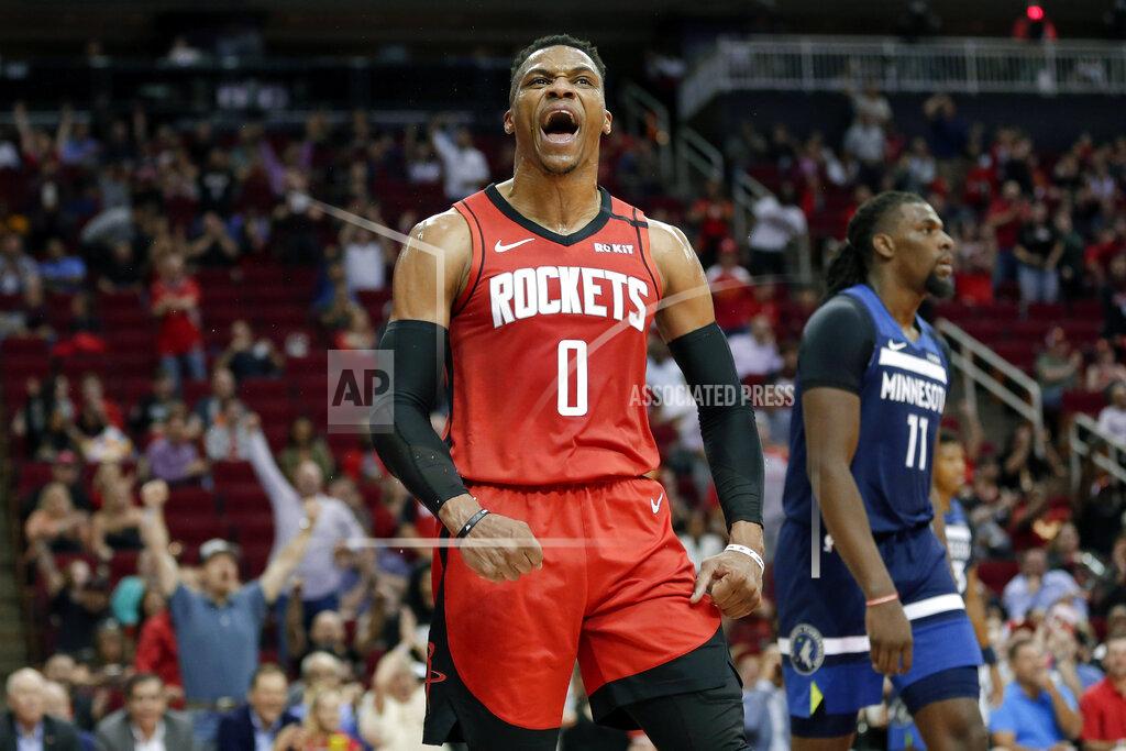 Michael Wyke Houston Rockets guard Russell Westbrook (0) reacts after a dunk, next to Minnesota Timberwolves center Naz Reid (11) during the second half of an NBA basketball game Tuesday, March 10, 2020, in Houston. (AP Photo/Michael Wyke)