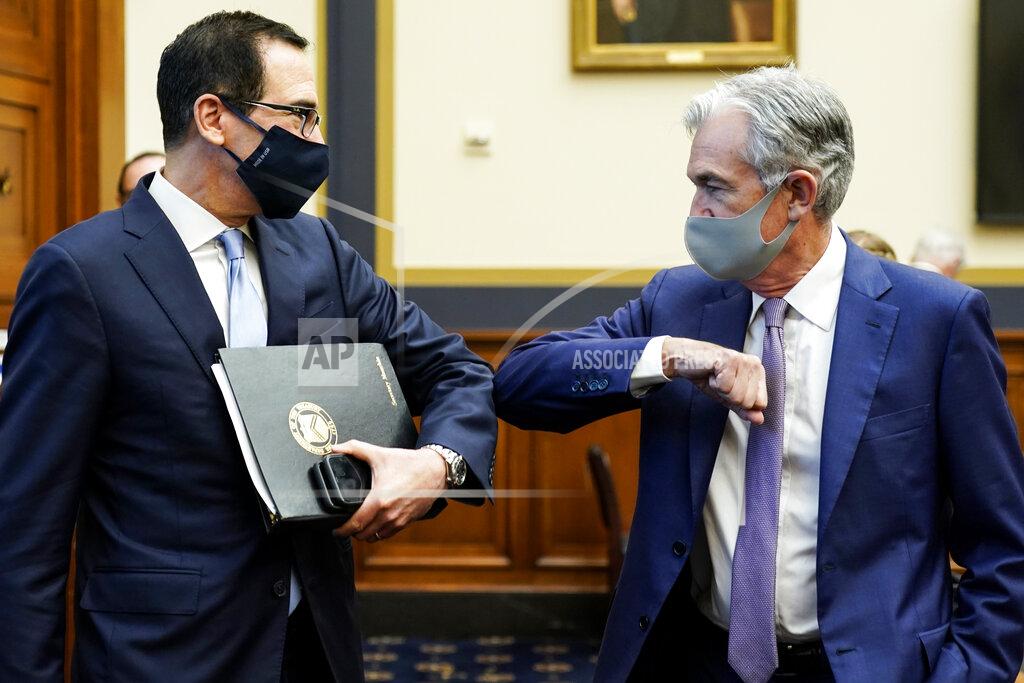 Treasury Secretary Steven Mnuchin, left, greets Federal Reserve Chair Jerome Powell with an elbow bump before the start of a House Financial Services Committee hearing about the government’s emergency aid to the economy in response to the coronavirus on Capitol Hill in Washington on Tuesday, Sept. 22, 2020. (Joshua Roberts/Pool via AP)