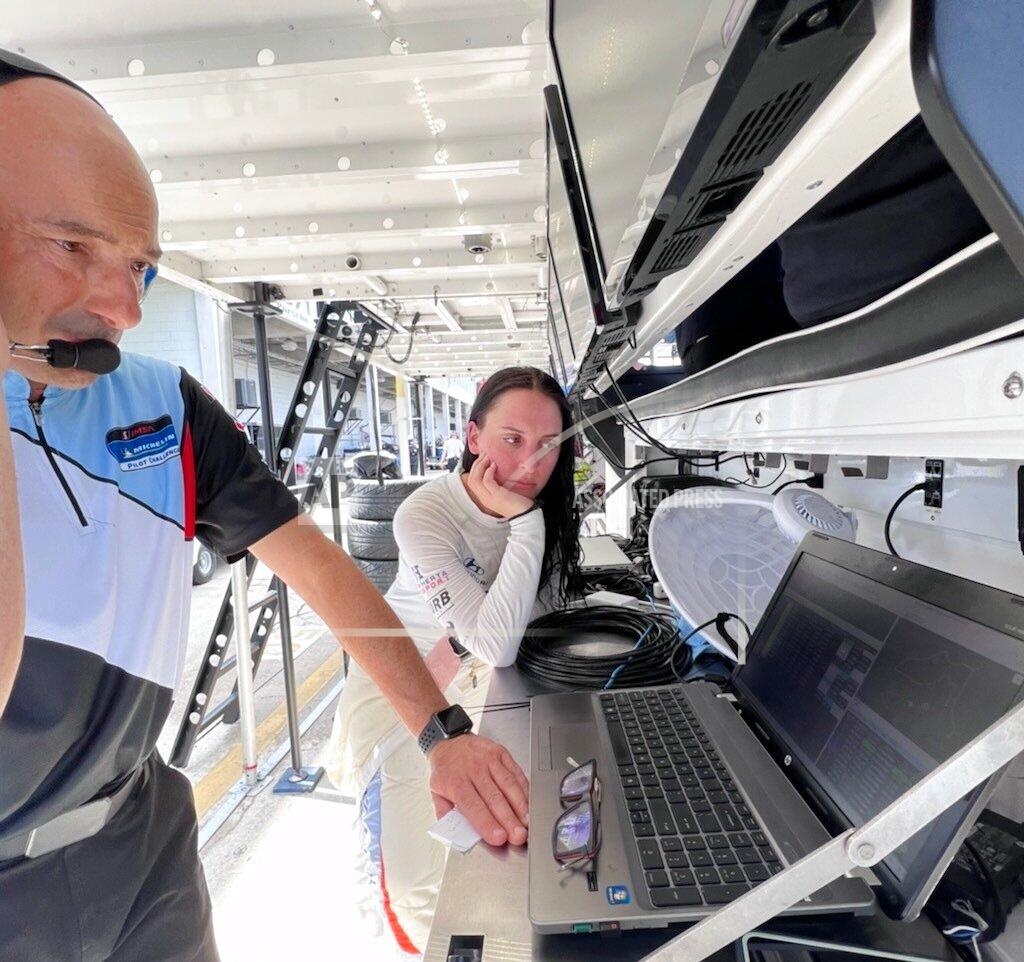 Jenna Fryer IMSA sports car driver Taylor Hagler, right, looks at data with engineer Stefano Galante on Wednesday March 16, 2022, at Sebring International Raceway in Sebring, Fla. Hagler drives for Bryan Herta Autosport and is the second female champion in IMSA history. She races Thursday at Sebring in The Michelin Pilot Challenge race. (AP Photo/Jenna Fryer)
