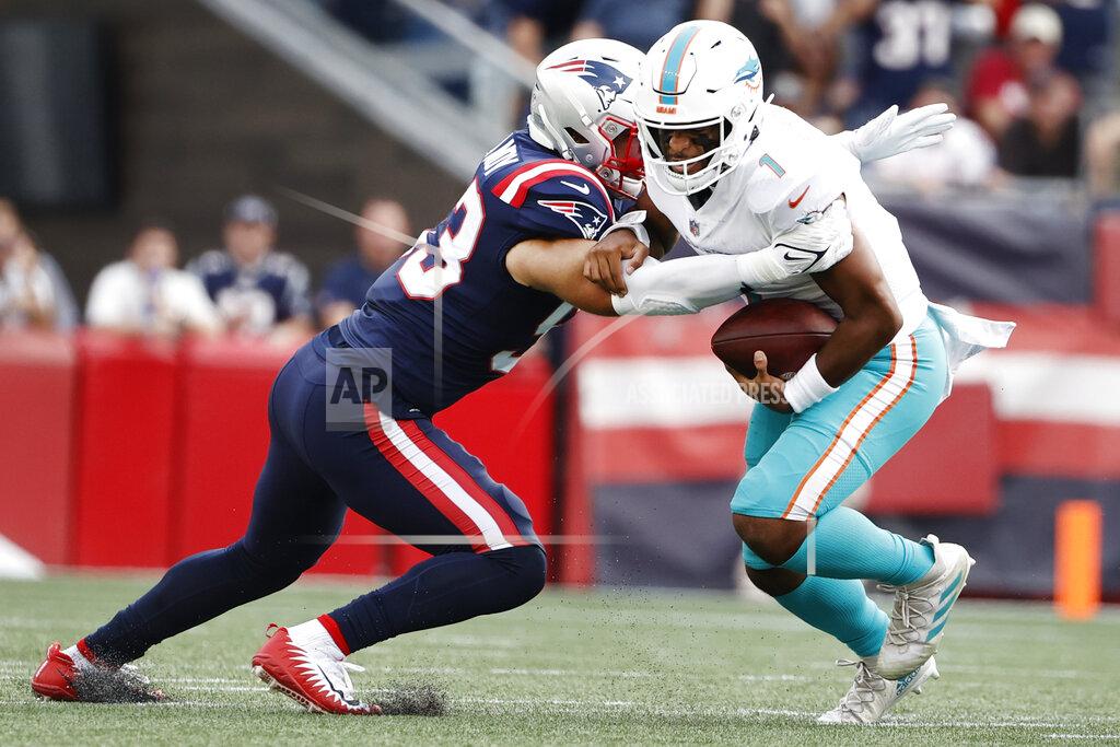 Winslow Townson New England Patriots middle linebacker Kyle Van Noy, left, takes down Miami Dolphins quarterback Tua Tagovailoa, right, during the first half of an NFL football game, Sunday, Sept. 12, 2021, in Foxborough, Mass. (AP Photo/Winslow Townson)