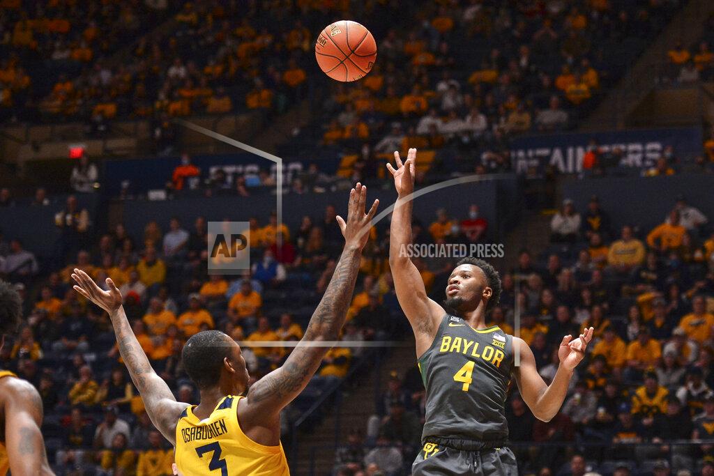 William Wotring Baylor guard LJ Cryer (4) shoots while being guarded by West Virginia forward Gabe Osabuohien (3) during the second half of an NCAA college basketball game in Morgantown, W.Va., Tuesday, Jan. 18, 2022. (William Wotring)