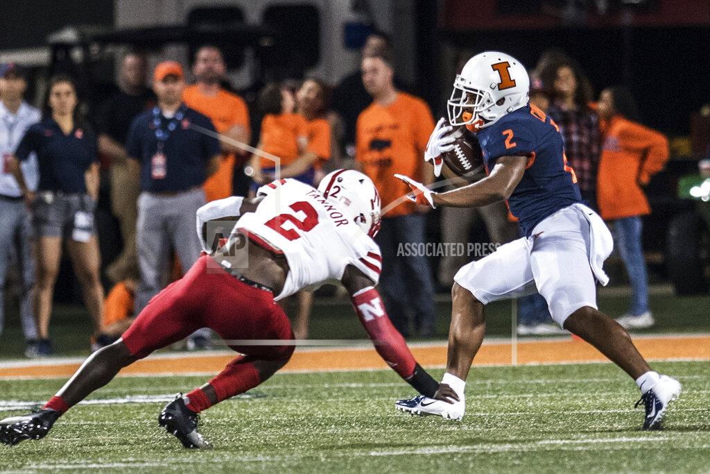 Holly Hart Illinois' Reggie Corbin (2) fends off Nebraska defender Caleb Tannor (2) in the first half of an NCAA college football game, Saturday, Sept. 21, 2019, in Champaign, Ill. (AP Photo/Holly Hart)
