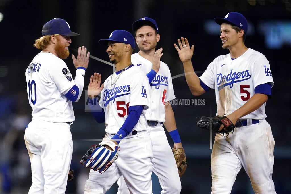 Marcio Jose Sanchez Los Angeles Dodgers' Justin Turner, Mookie Betts, Trea Turner and Corey Seager, from left, celebrate the team's 8-4 win over the Arizona Diamondbacks in a baseball game Tuesday, Sept. 14, 2021, in Los Angeles. (AP Photo/Marcio Jose Sanchez)