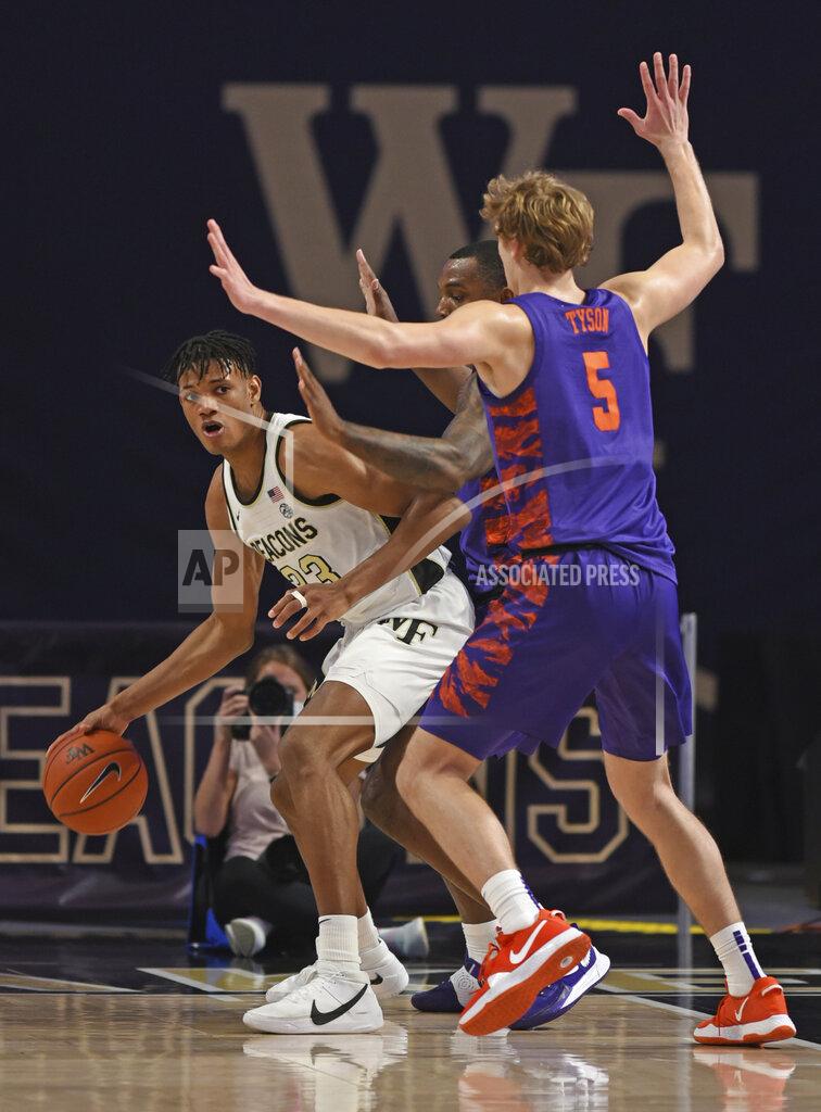 Walt Unks Wake Forest's Ody Oguama, left, looks for help as he is guarded by Clemson's Clyde Trapp and Hunter Tyson during the first half of an NCAA college basketball game, Wednesday, Feb. 24, 2021 at Joel Coliseum in Winston-Salem, N.C. (Walt Unks/The Winston-Salem Journal via AP, Pool)