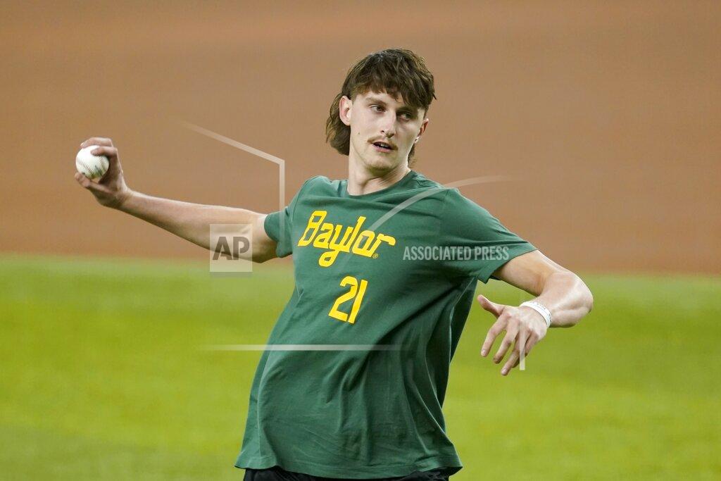 Tony Gutierrez Baylor basketball player Matthew Mayer throws out a first pitch before a baseball game between the Seattle Mariners and the Texas Rangers in Arlington, Texas, Friday, July 30, 2021. (AP Photo/Tony Gutierrez)