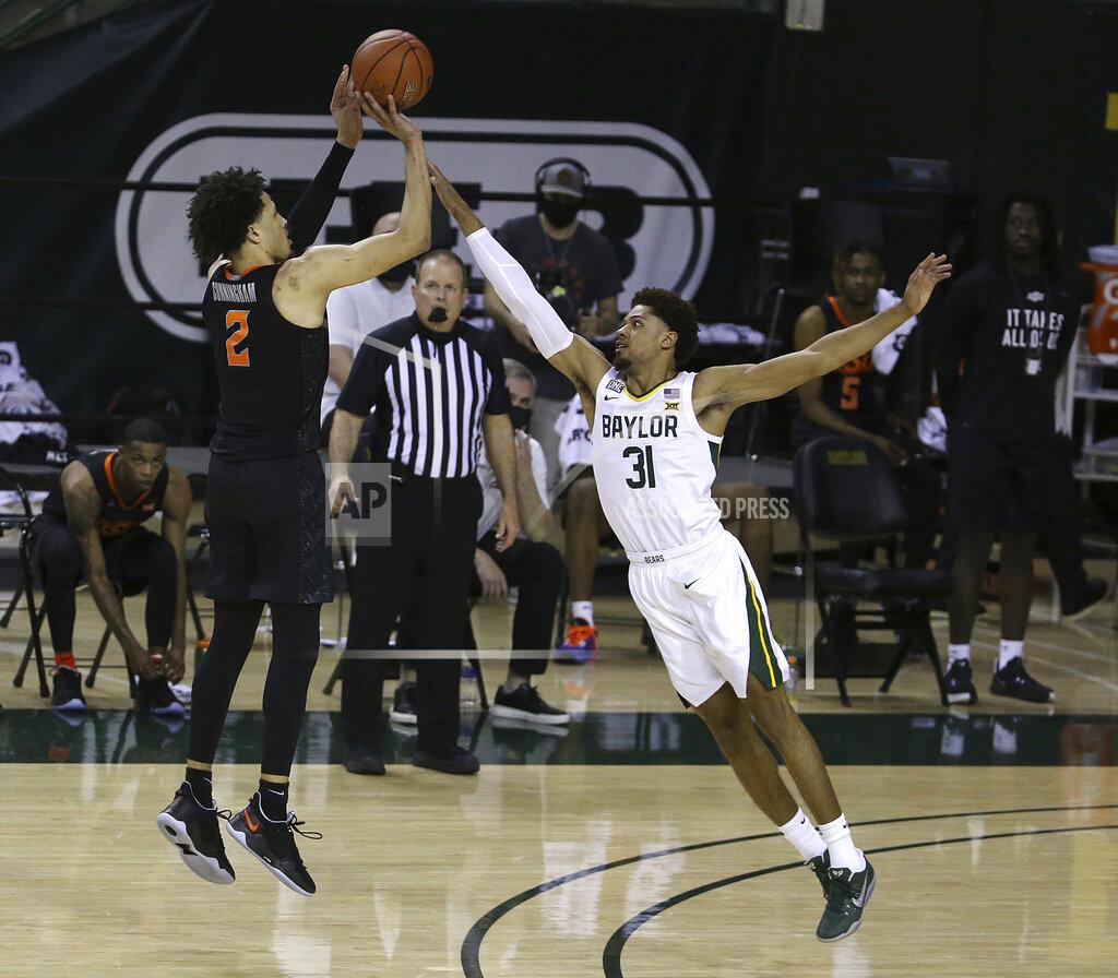 Jerry Larson Oklahoma State guard Cade Cunningham (2) shoots a three point shot over Baylor guard MaCio Teague (31) in the second half of an NCAA college basketball game, Thursday, March 4, 2021, in Waco, Texas. (AP Photo/Jerry Larson)