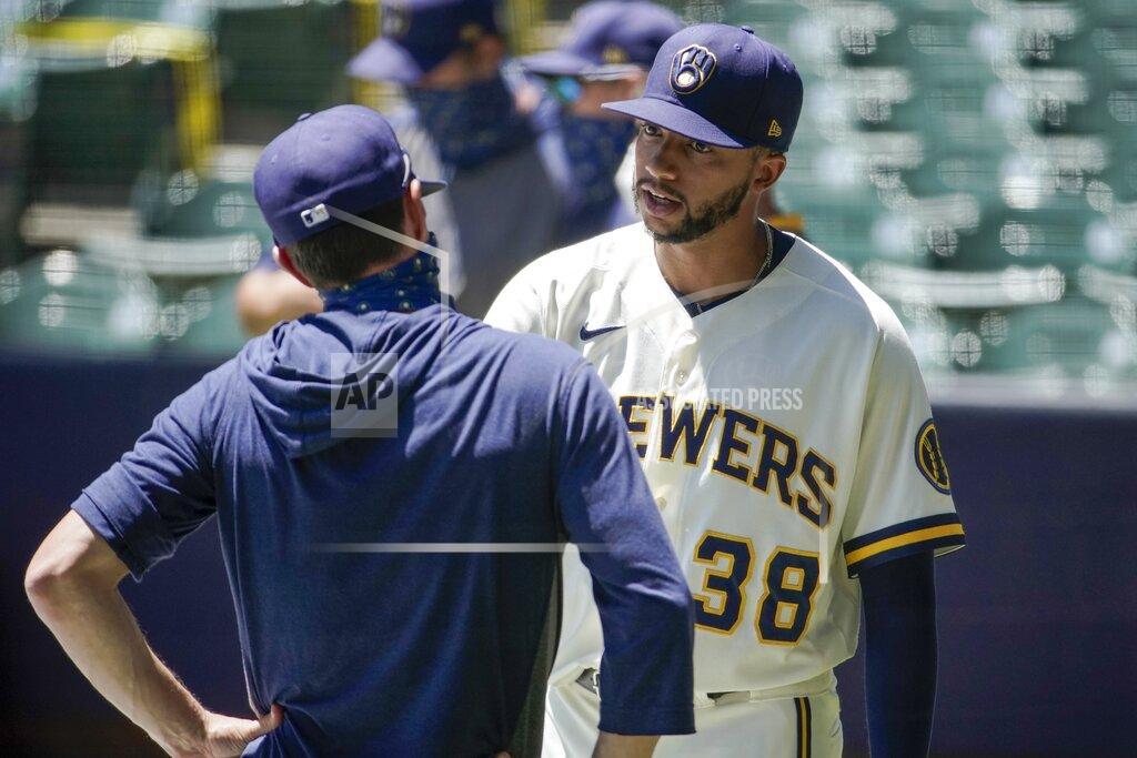 Morry Gash Milwaukee Brewers' Devin Williams talks to manager Craig Counsell during a practice session Monday, July 13, 2020, at Miller Park in Milwaukee. (AP Photo/Morry Gash)