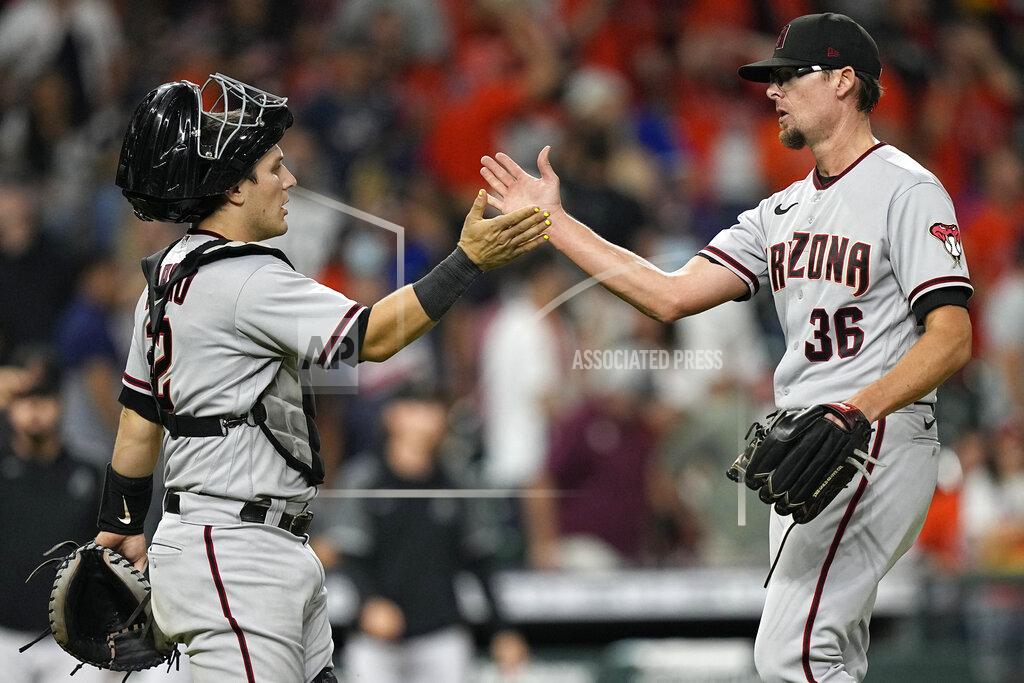 David J. Phillip Arizona Diamondbacks' Daulton Varsho (12) and Tyler Clippard (36) celebrate after a baseball game against the Houston Astros Saturday, Sept. 18, 2021, in Houston. The Diamondbacks won 6-4 in 10 innings. (AP Photo/David J. Phillip)