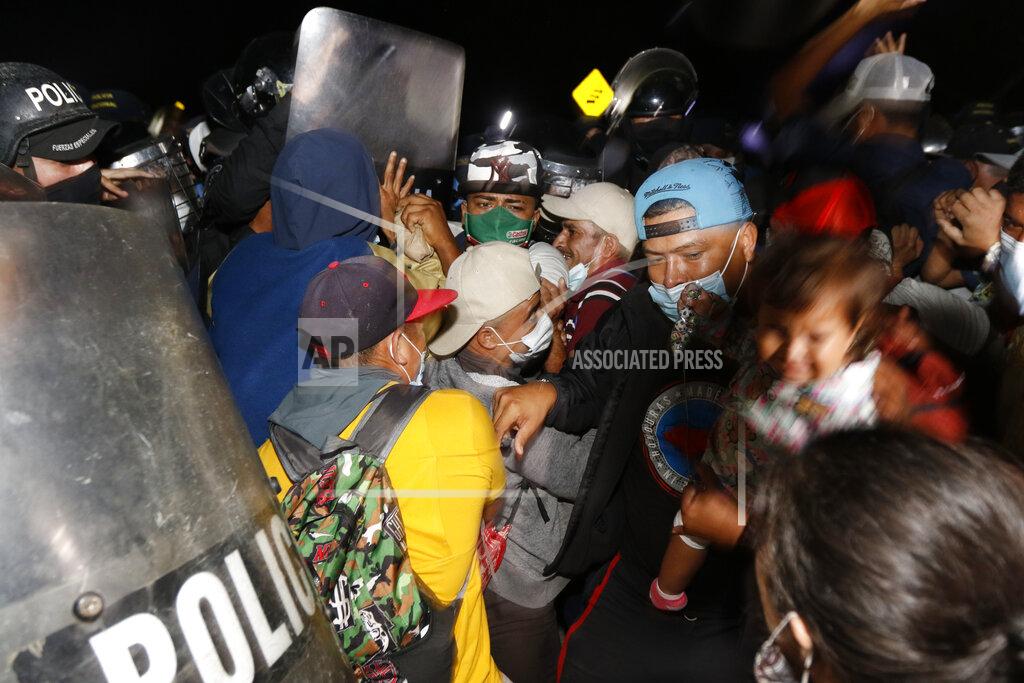 Delmer Martinez Honduran security forces try to keep migrants who are trying to reach the U.S. from crossing into Guatemala at the border in El Florido, Honduras, Friday, Jan. 15, 2021. (AP Photo/Delmer Martinez)