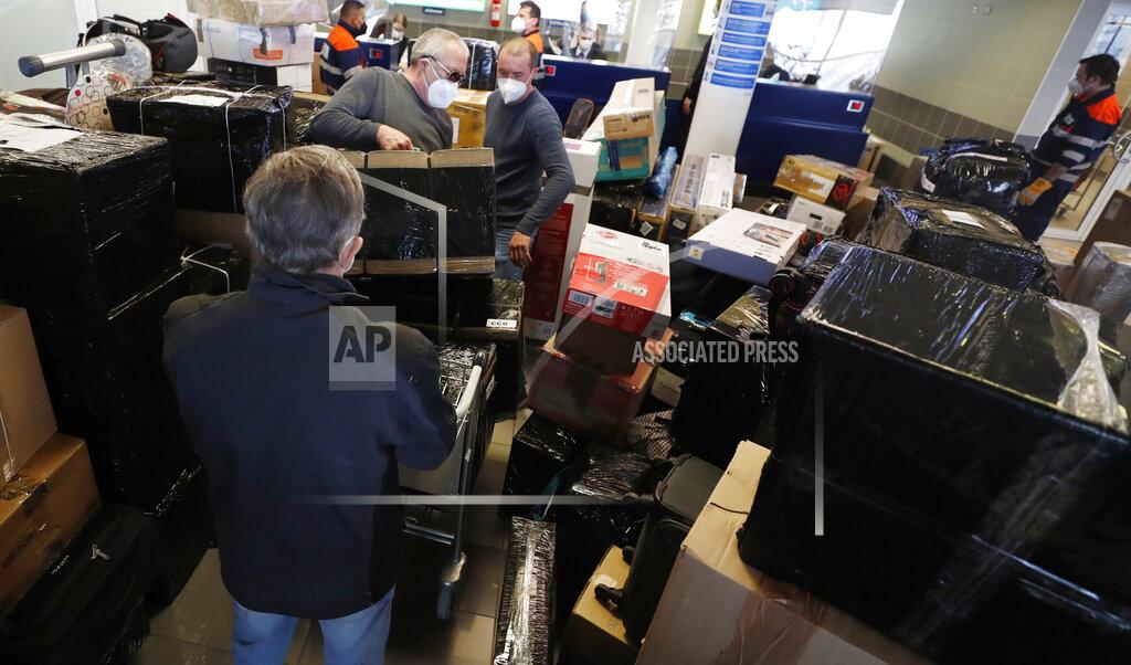 Petr David Josek People check in luggages at the Vaclav Havel airport after a Russian special government plane landed in Prague, Czech Republic, Monday, April 19, 2021. Czech Republic is expelling 18 diplomats identified as spies over a 2014 ammunition depot explosion. On Saturday, April 17, 2021, Prime Minister Andrej Babis said the Czech spy agencies provided clear evidence about the involvement of Russian military agents in the massive explosion that killed two people. (AP Photo/Petr David Josek)
