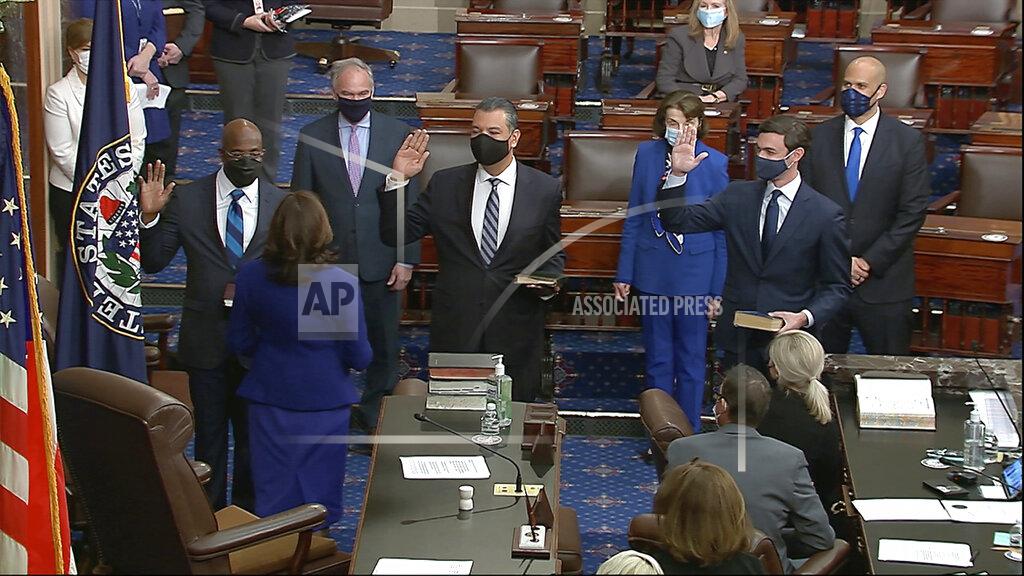 Uncredited In this image from video, Vice President Kamala Harris swears in Sen. Raphael Warnock, D-Ga., Sen. Alex Padilla, D-Calif., and Sen. Jon Ossoff, D-Ga., on the floor of the Senate Wednesday, Jan. 6, 2021, on Capitol Hill in Washington. (Senate Television via AP)