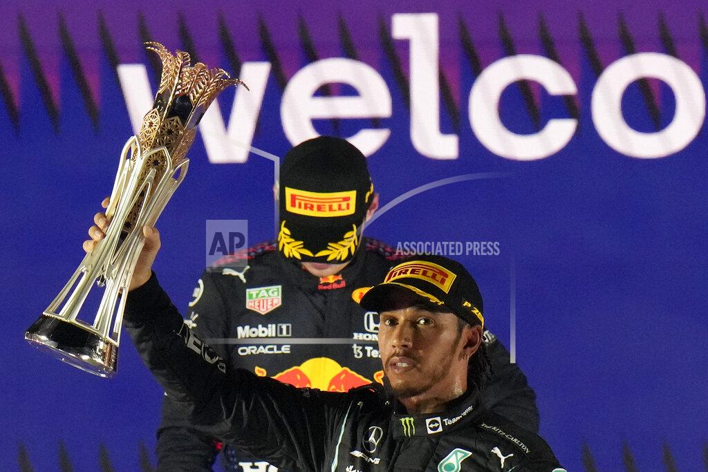Hassan Ammar Mercedes driver Lewis Hamilton of Britain celebrates winning the Formula One Saudi Arabian Grand Prix in front of the second placed Red Bull driver Max Verstappen of the Netherlands, in Jiddah, Sunday, Dec. 5, 2021. (AP Photo/Hassan Ammar)