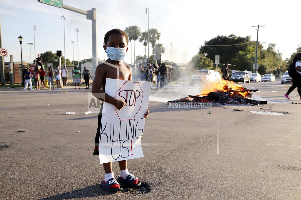 Douglas R. Clifford Five-year-old Michael Veteri stands at an intersection where the road remained closed during a protest Sunday, May 31, 2020, in Tampa Fla., over the death of George Floyd. Floyd died May 25 after he was pinned at the neck by a Minneapolis police officer. (Douglas R. Clifford/Tampa Bay Times via AP)
