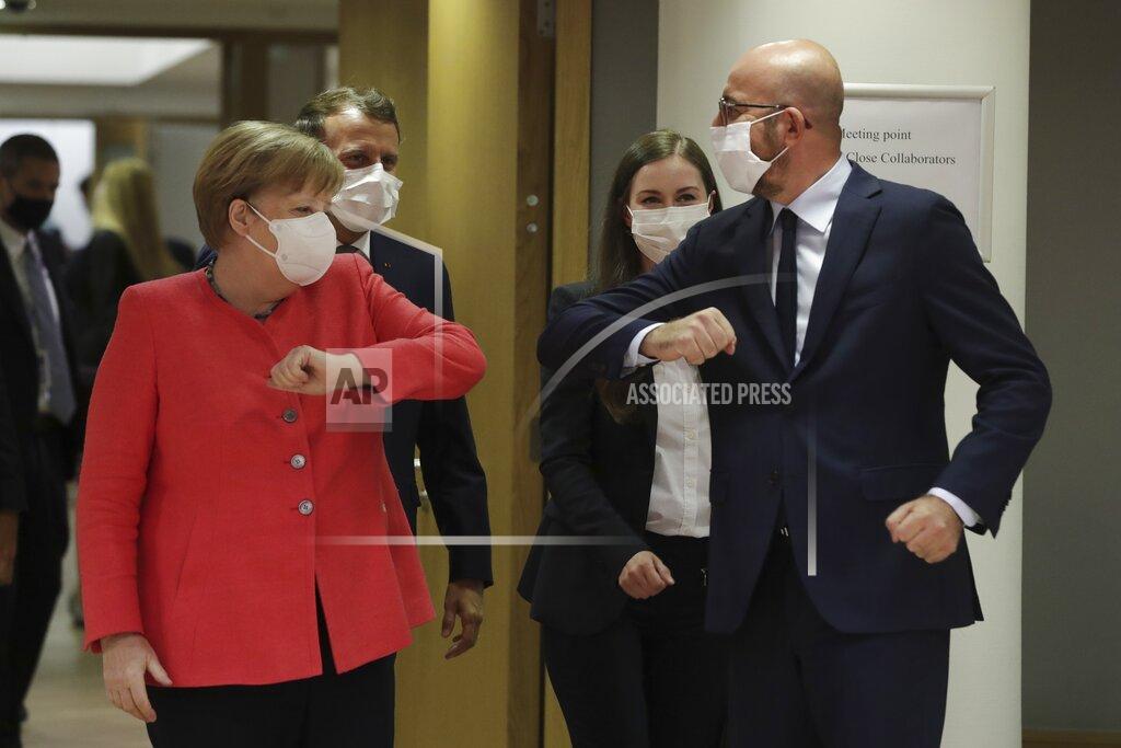 Stephanie Lecocq European Council President Charles Michel, right, greets German Chancellor Angela Merkel, left, with an elbow bump during a round table meeting at an EU summit in Brussels, Friday, July 17, 2020. Leaders from 27 European Union nations meet face-to-face on Friday for the first time since February, despite the dangers of the coronavirus pandemic, to assess an overall budget and recovery package spread over seven years estimated at some 1.75 trillion to 1.85 trillion euros. (Stephanie Lecocq, Pool Photo via AP)