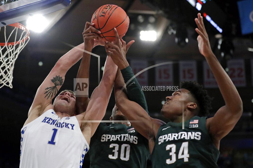 Adam Hunger Kentucky forward Nate Sestina (1) vies for a rebound with Michigan State forwards Marcus Bingham Jr. (30) and Julius Marble (34) during the first half of an NCAA college basketball game Tuesday, Nov. 5, 2019, in New York. (AP Photo/Adam Hunger)